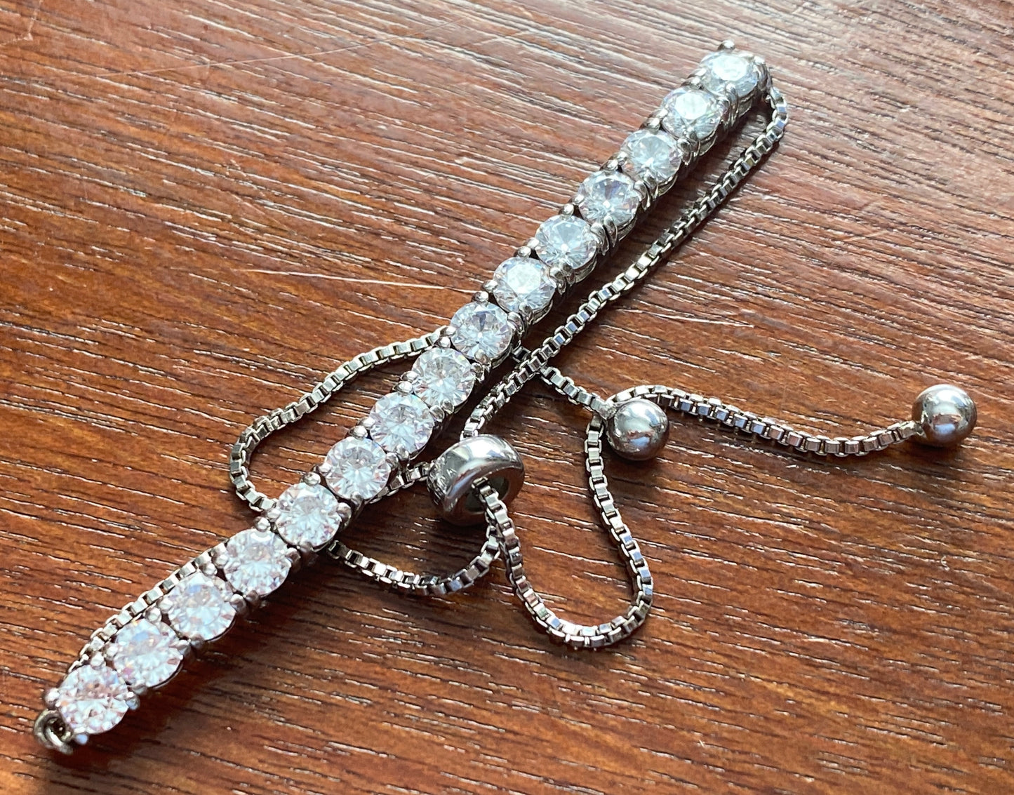 JCM Cubic Zirconia Silver Tone Metal Adjustable Slide Tennis Bracelet
