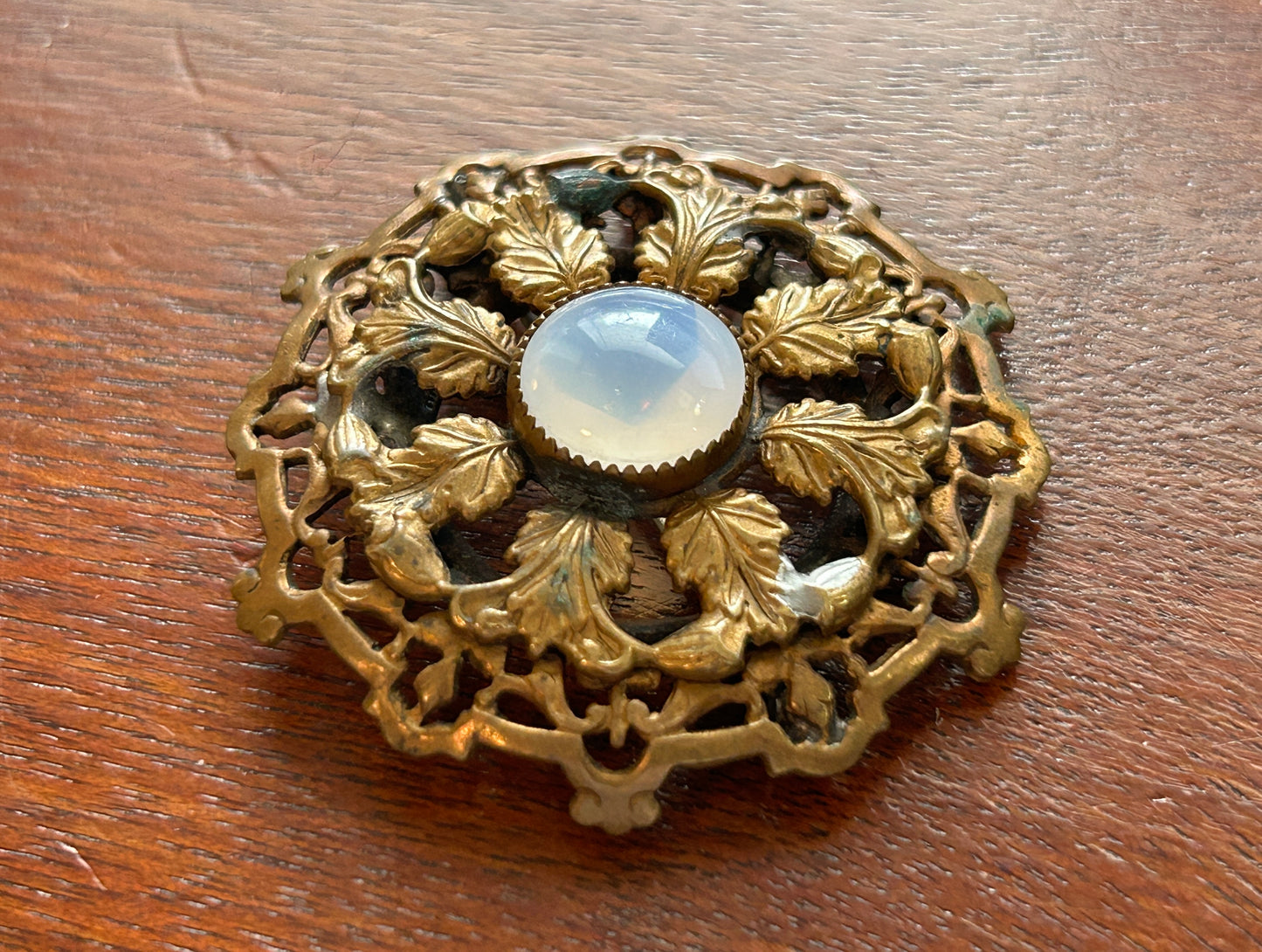 Vintage Round Filigree Gold Tone Brooch With Clear Milky Cabochon Stone